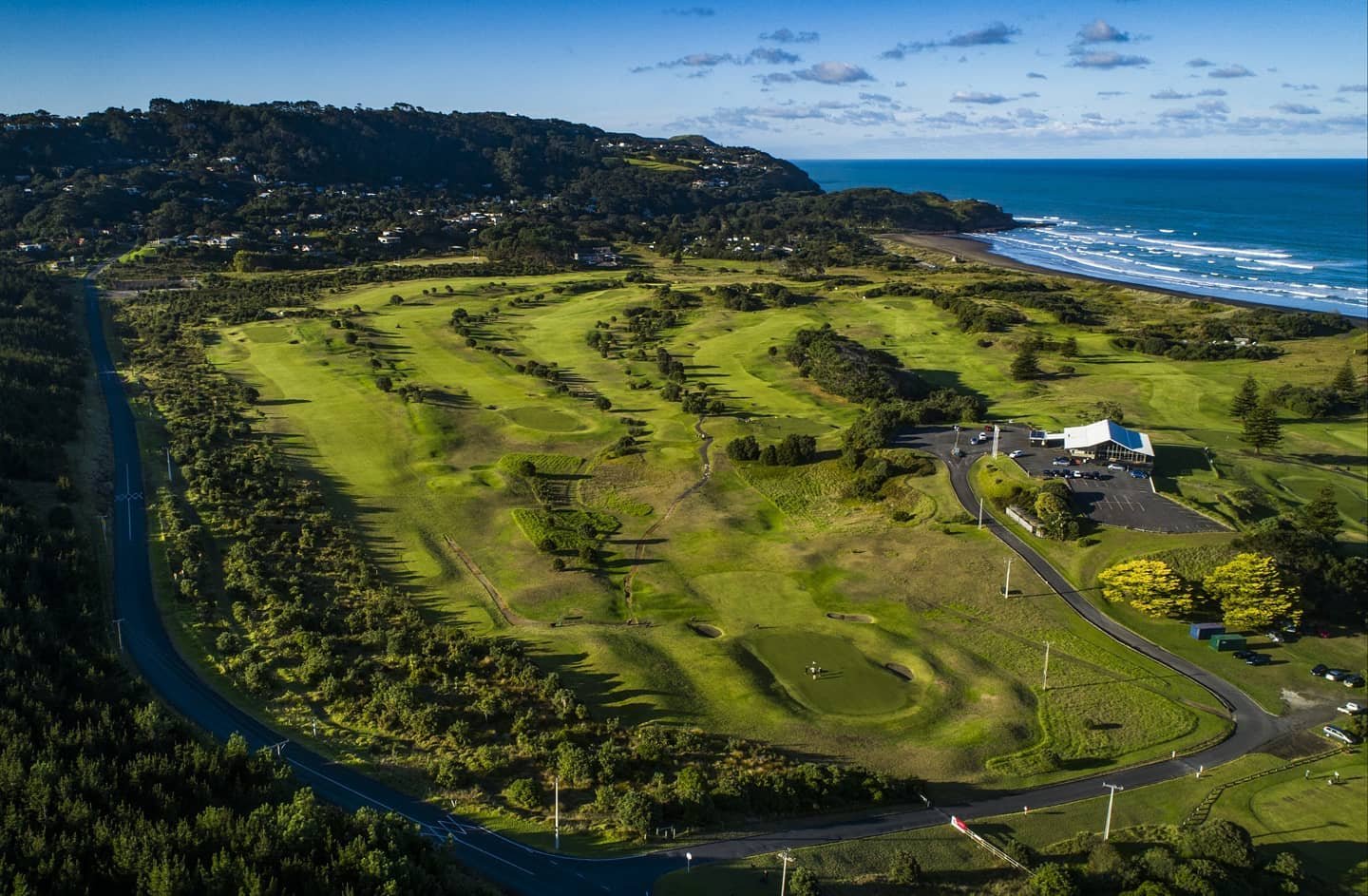 Muriwai Golf Club clubhouse and fairways beside the coast