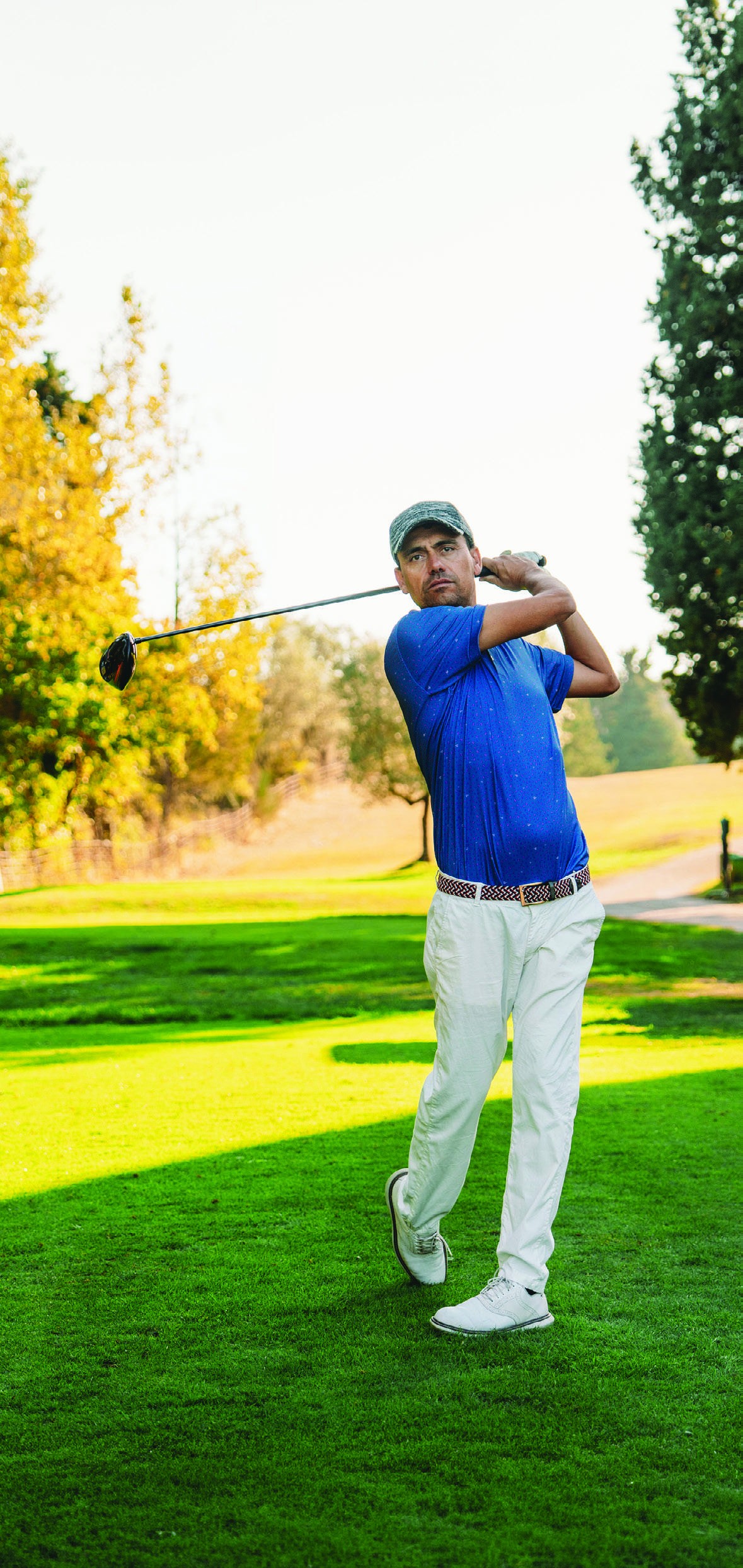 A golfer following the flight of his ball after a drive
